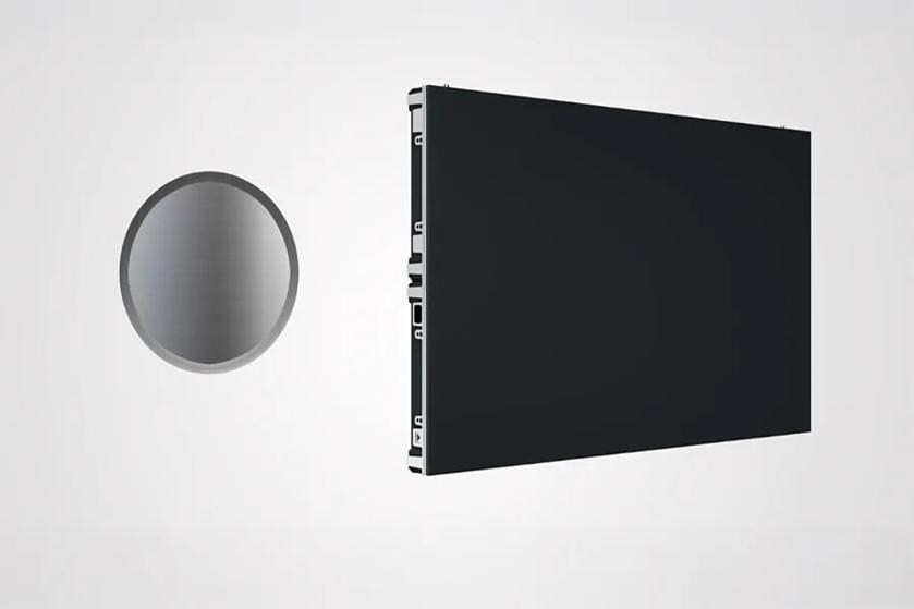 A circular metallic disc and a rectangular black panel against a light gray background.
