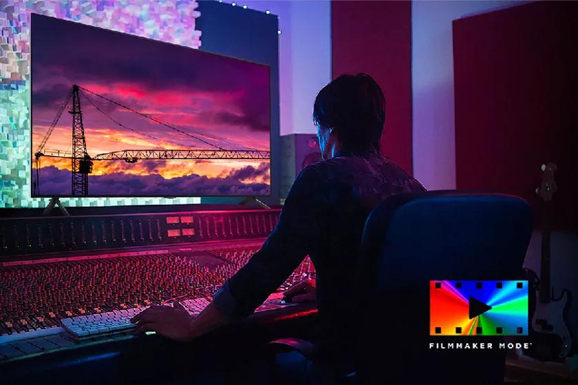 Person making adjustments at a control panel. FILMMAKER MODE logo.