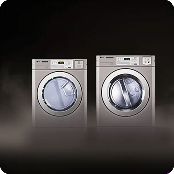 Two LG commercial front-load laundry machines side by side against a dark background.