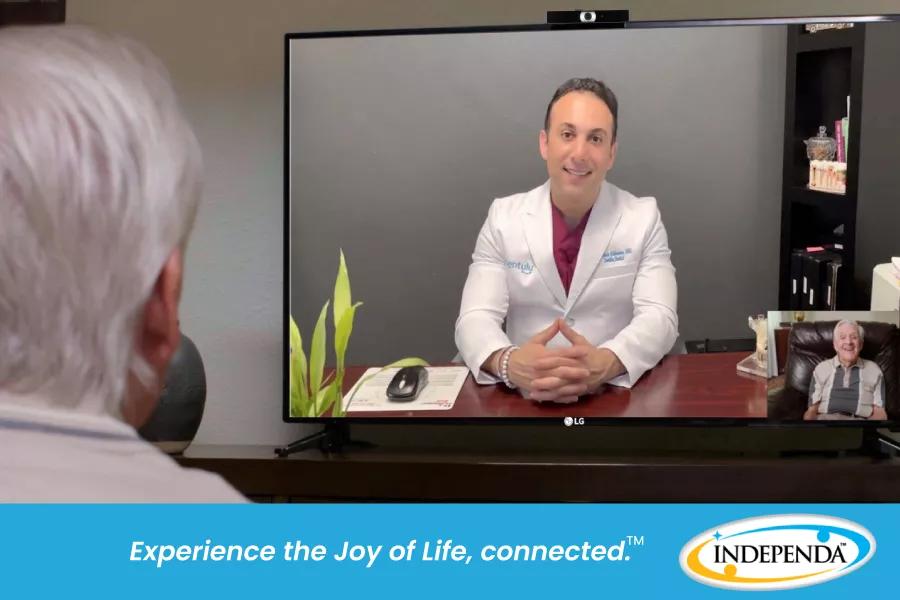 A doctor conducts a telehealth visit via the patient's TV.