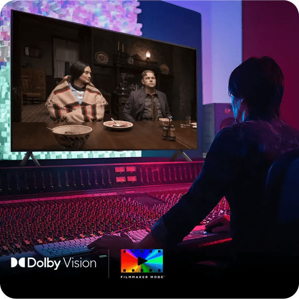 Sound engineer working in dark studio with LG monitor displaying film scene in Dolby Vision with rich, accurate colors.