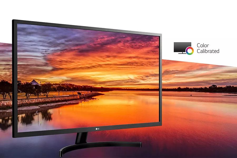 monitor display showing colorful sunset by a shoreline horizon