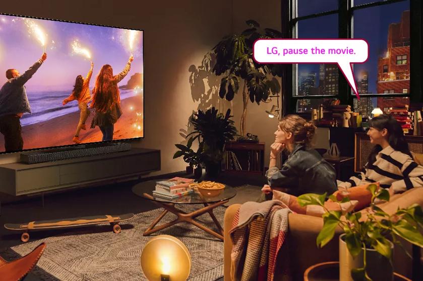 A person watching TV. Text: LG, pause the movie.