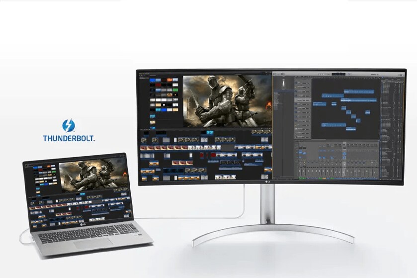Workspace with laptop and ultra-wide monitor connected via Thunderbolt, displaying video and audio editing software.