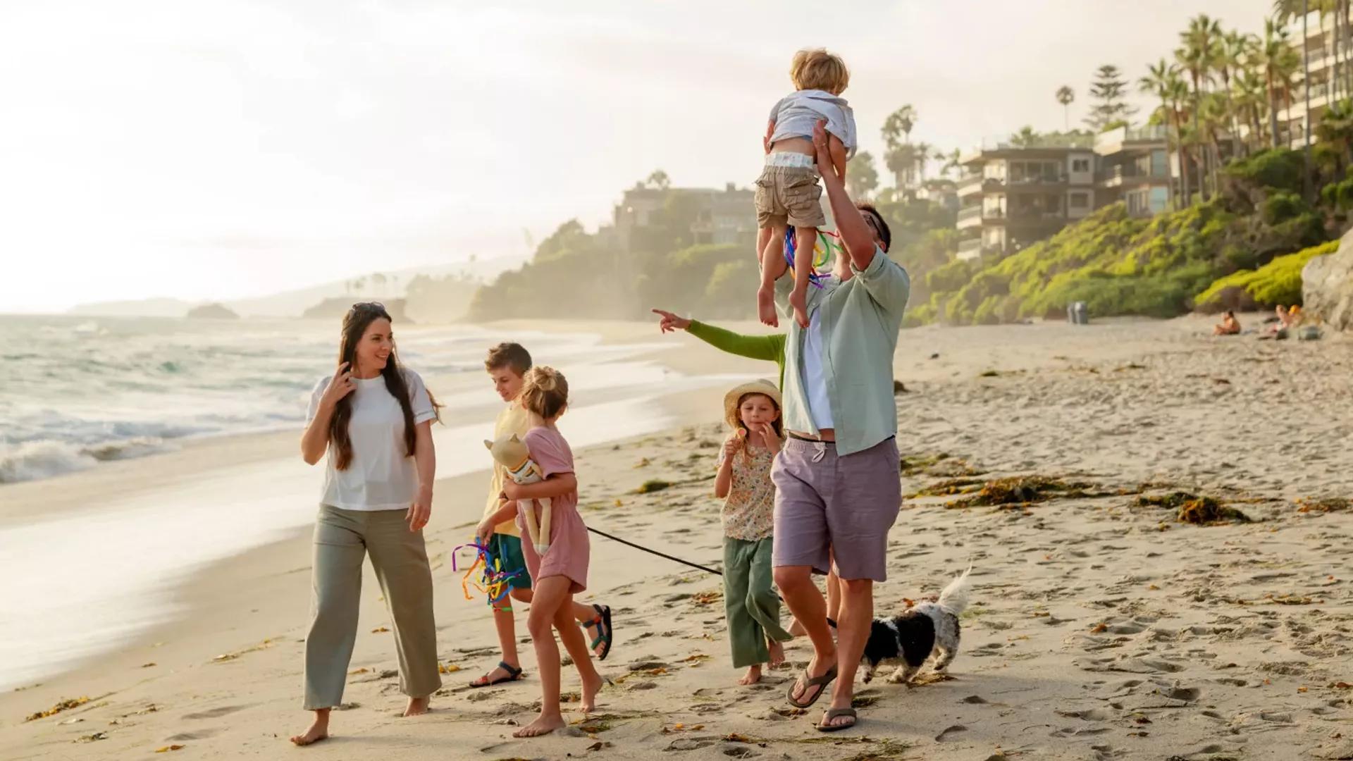 Family playing on a beach.