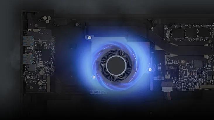 Close-up of a computer's interior showing a glowing blue fan surrounded by electronic components.