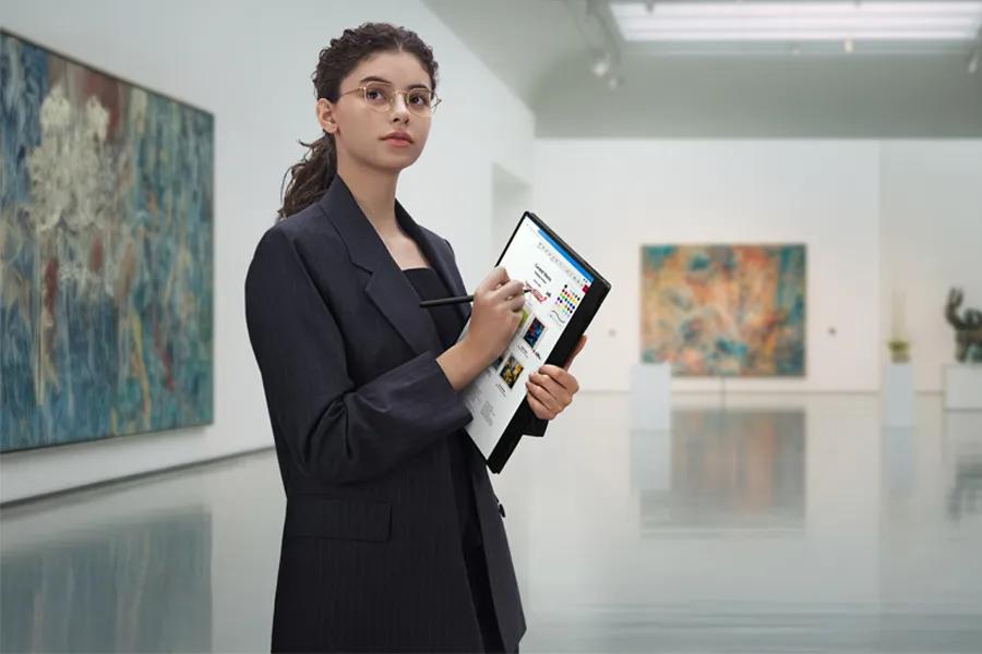 LG Gram 16T95TP-K.AA77U1 laptop in tablet mode with stylus being used in art gallery showing portability and versatility