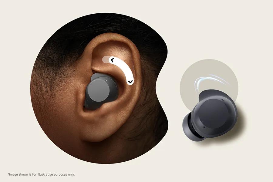 Image of one earbuds in an ear showcasing the stabalizing fin to adjust