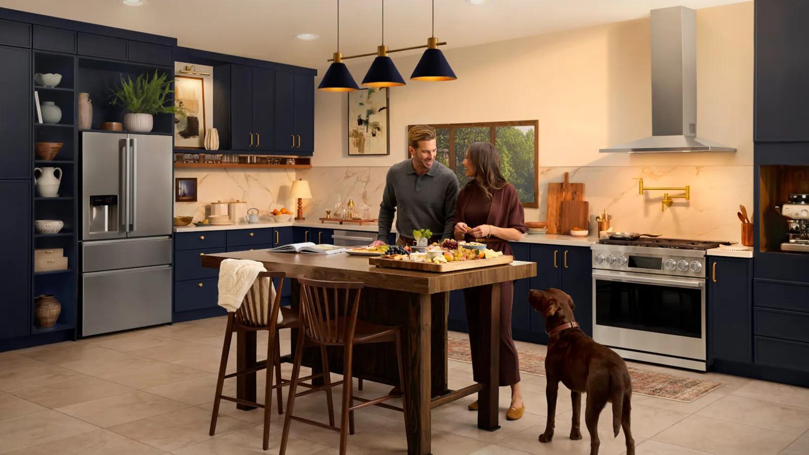 A couple in a modern kitchen setting, showcasing various LG Signature Collections and appliances.