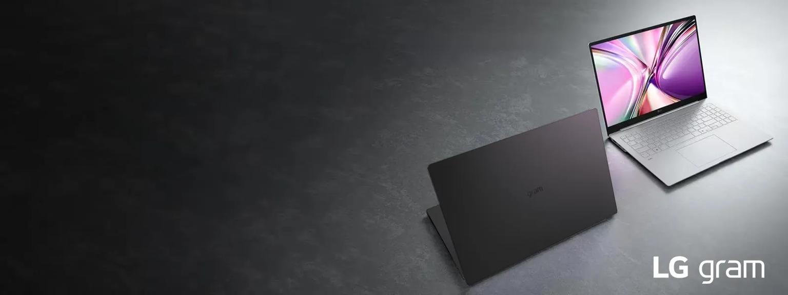 Two new LG grams on a dark background