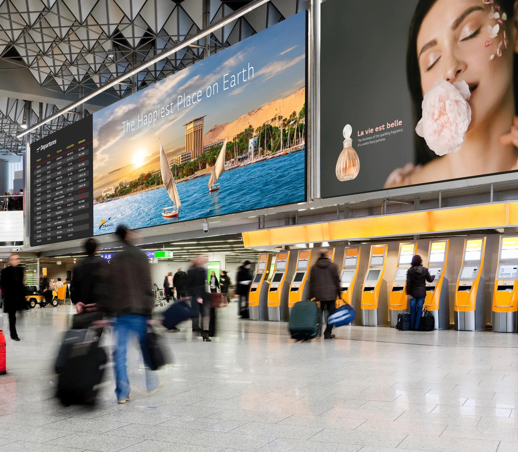 Busy airport terminal with travelers, two large ads, a departures board, and check-in kiosks.