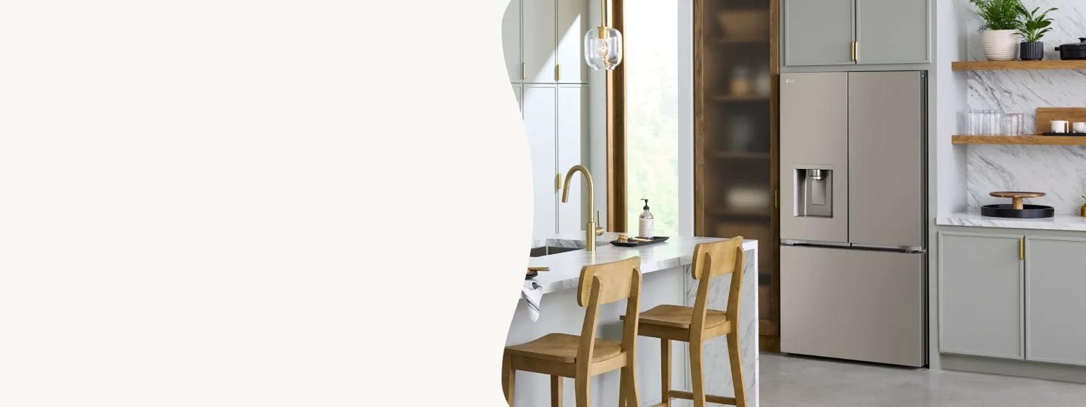 A modern kitchen features a stainless steel LG French-door refrigerator integrated into light grey cabinetry with elegant gold hardware. The scene includes a marble-patterned countertop and backsplash, accented by open wooden shelves and natural wood barstools at an island.