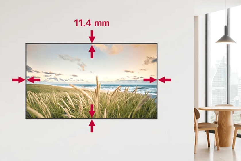 Flat-screen TV on a white wall displaying a landscape with 11.4 mm frame measurement.