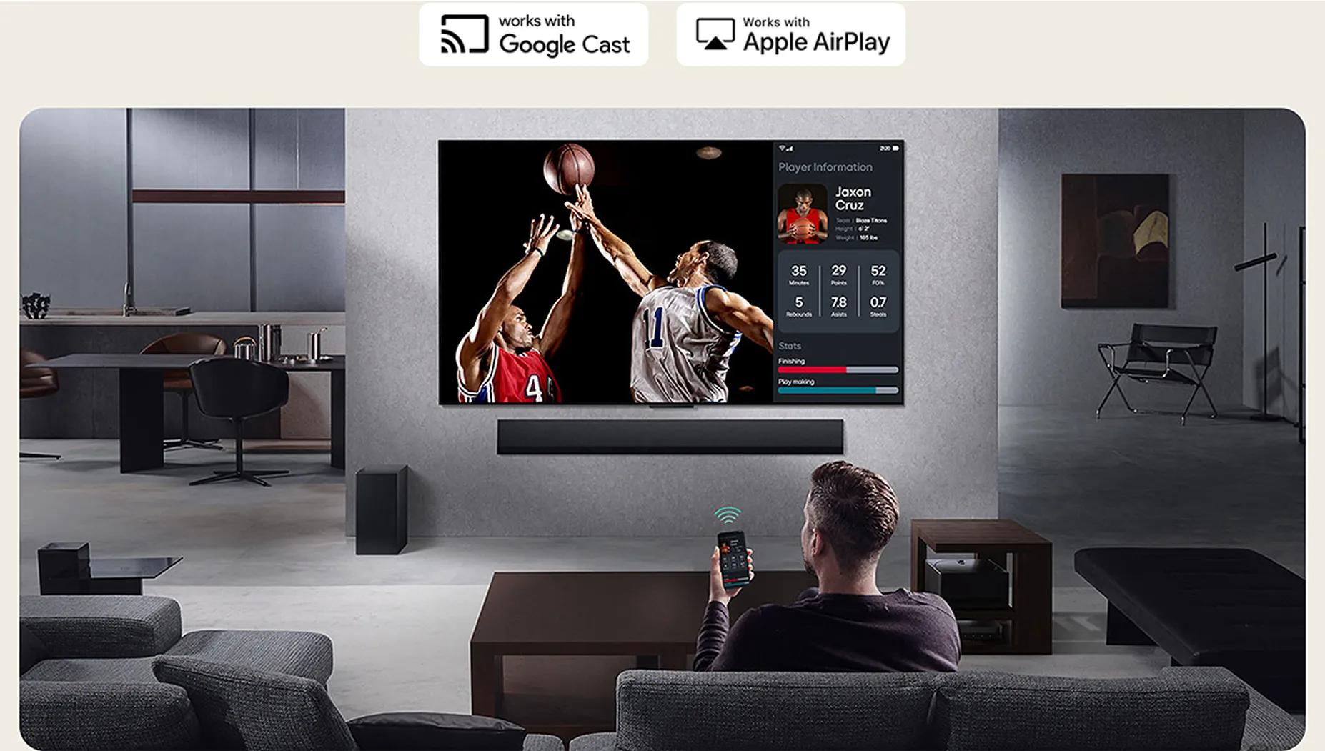 Man watching live basketball game on LG TV with player stats overlay and controlling playback with phone.