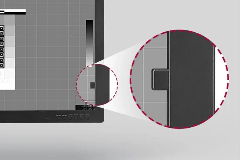 LG diagnostic monitor showing a medical image and a magnified view of the calibration sensor on the screen edge.