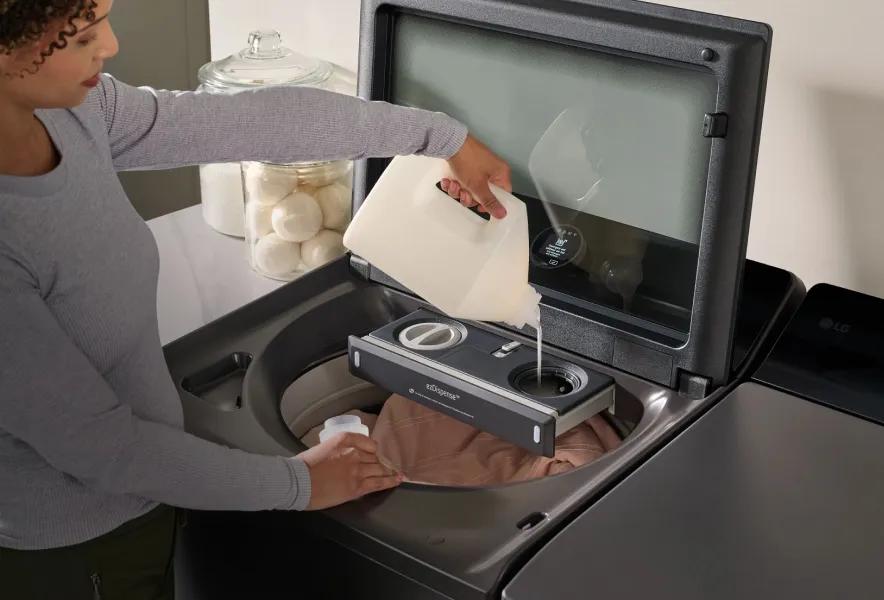 Woman adding detergent to the ezDispense automatic dispenser in an LG washer.