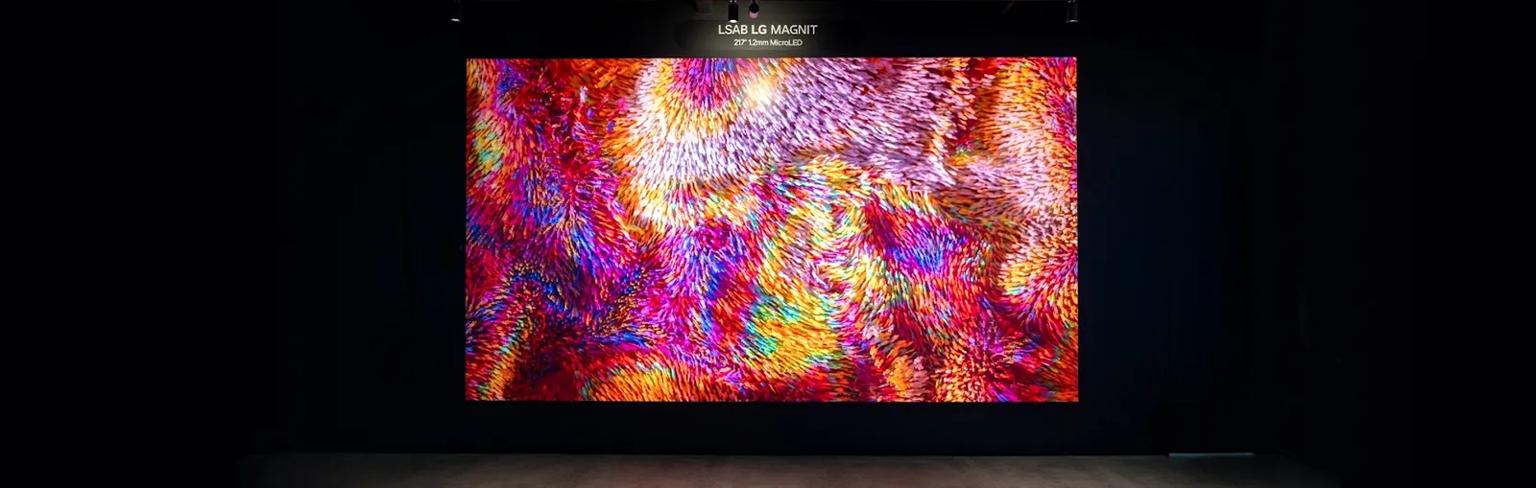 A brightly colored MAGNIT Direct View LED display stands out in the low-lit Business Innovation Center.