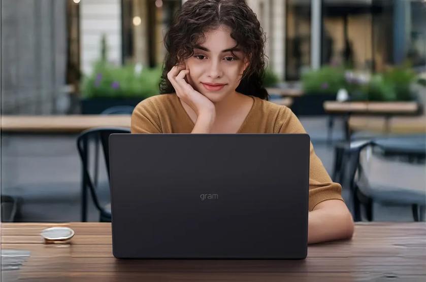 A young professional works remotely with LG gram laptop at an outdoor cafe