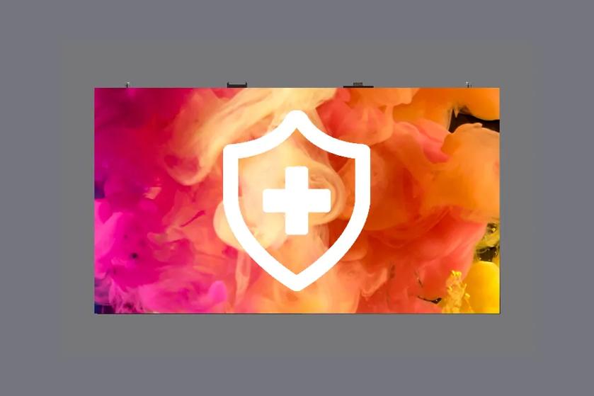 A shield with a plus sign over a colorful background of pink, orange, and yellow swirls.