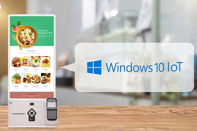 Digital kiosk displaying a restaurant menu with a Windows 10 IoT logo on the right.