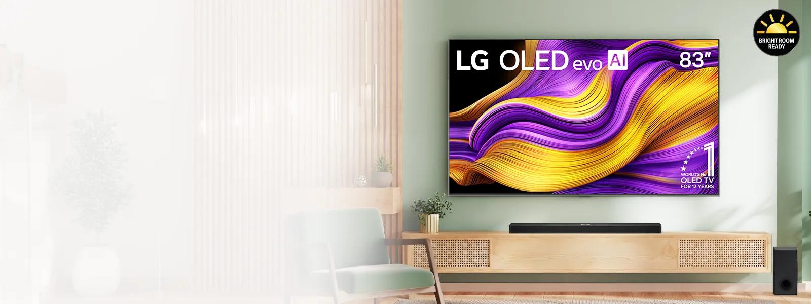 A modern living room featuring an 83-inch LG OLED evo AI TV mounted on a green wall. The TV displays a vibrant abstract image with purple and gold waves. A wooden console with a soundbar and a speaker is placed beneath the TV. The room is decorated with a mint green armchair, potted plants, and wooden paneling. A "Bright Room Ready" badge is visible in the top right corner.