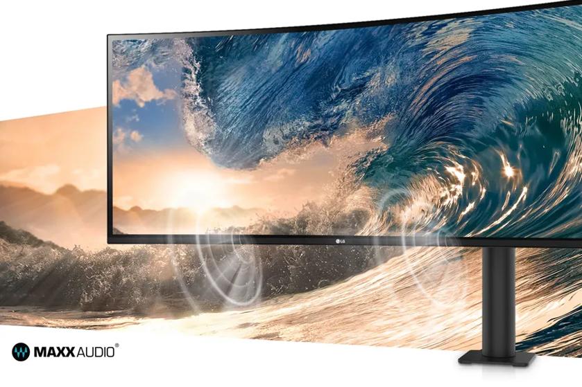 A curved monitor displaying ocean waves, with a scenic sunset in the background, and "MAXXAUDIO" branding on the bottom left.