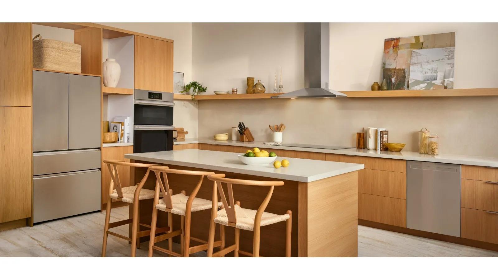 Warm wood-toned kitchen with a French door refrigerator, wall oven and cooktop fully integrated into the cabinetry.