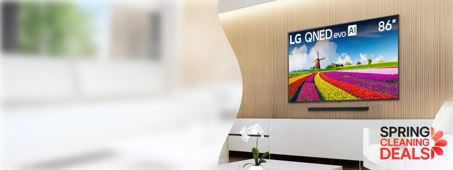 Modern living room featuring an 86-inch LG QNED evo AI TV displaying a vibrant image of a tulip field and windmill, with a “Bright Room Ready” badge and “Spring Cleaning Deals” promotion.