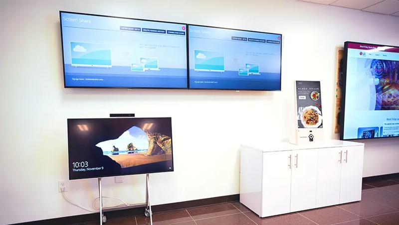 Various LG signage options on display in the LG Atlanta Business Innovation Center, including standard digital signage and a touch kiosk.