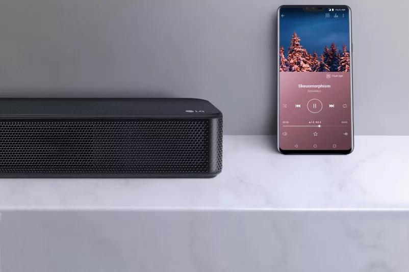 SL5Y Going Wireless Is Effortless - soundbar next a smart phone