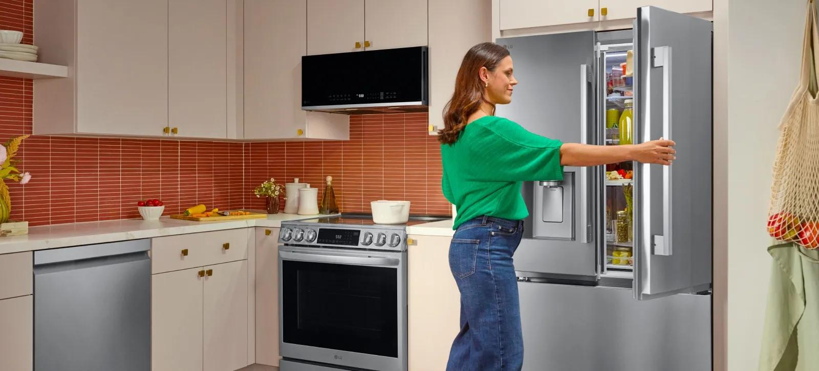 Front of stainless steel Counter-Depth MAX Refrigerator with Zero Clearance set in a modern white kitchen.