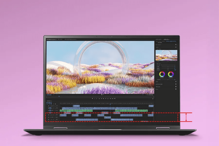 Laptop displaying video editing software interface with a colorful digital landscape scene and timeline.