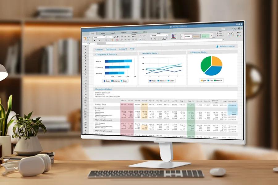 27U511SB-W LG Monitor displaying business dashboard with charts and data on wooden desk