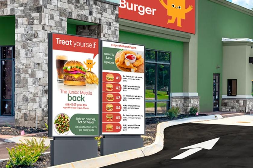 A fast food drive through with LG direct view LED on the building and outdoor stand displays for the menu. 