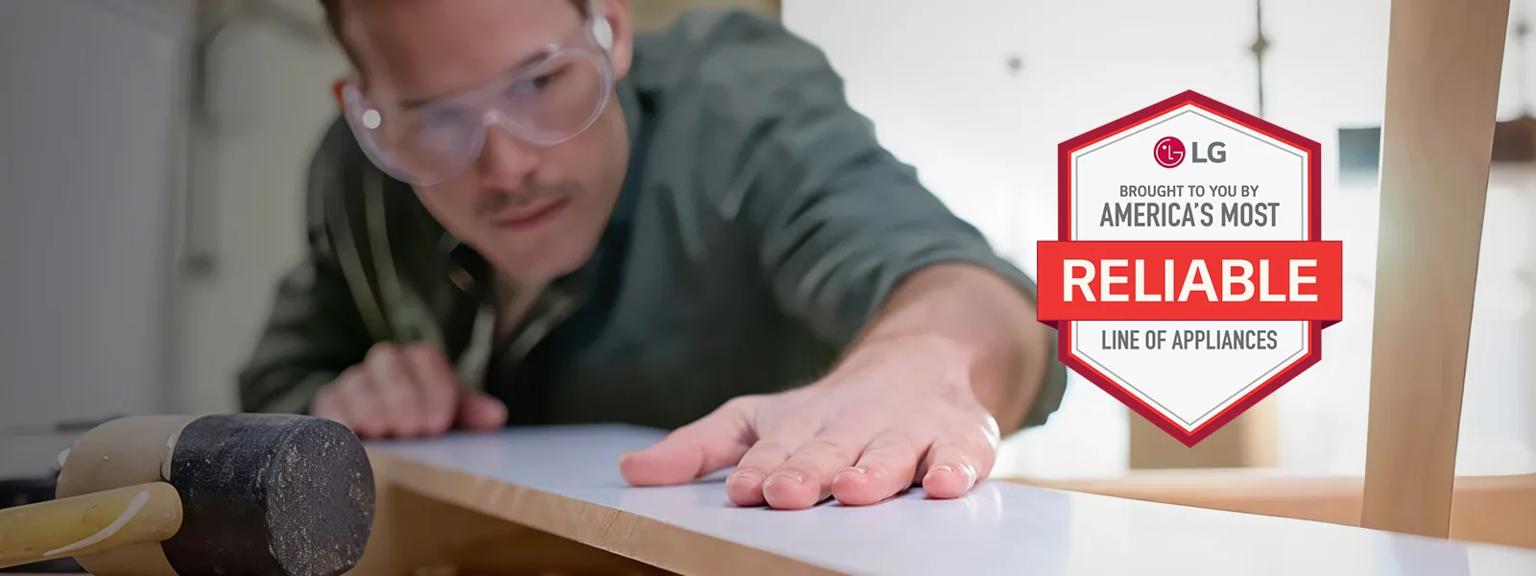 Contractor checking his work. “America’s Most Reliable Line of Home Appliances” badge.