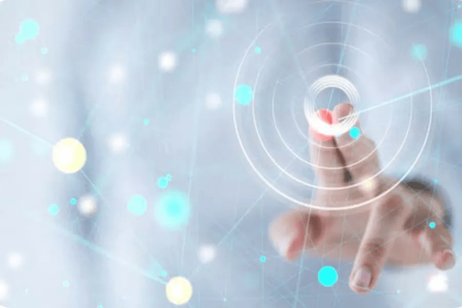 Finger touching a digital interface with concentric circles and a network of bright dots.