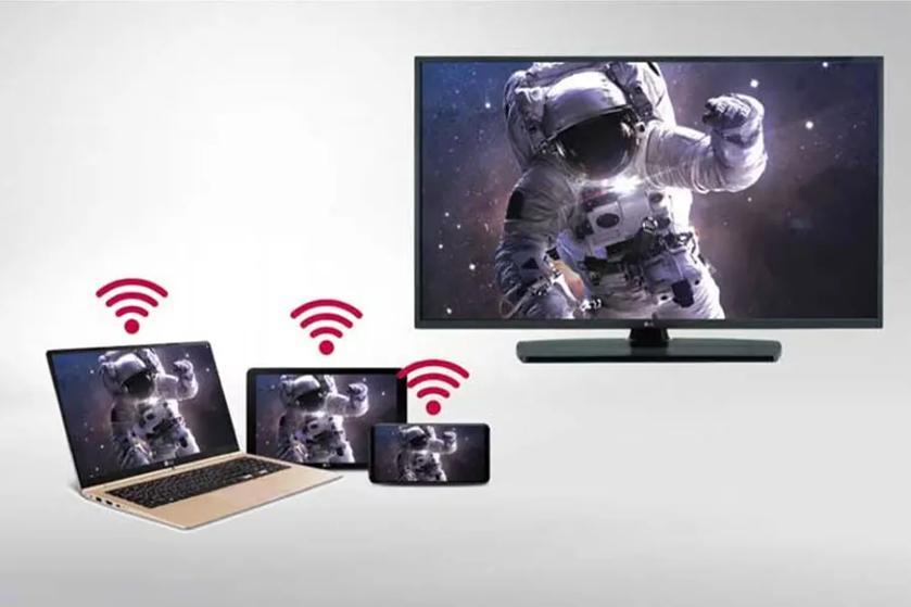 The image displays a large television screen and three smaller electronic devices, including a laptop, tablet, and smartphone. All four screens show the same image of an astronaut floating in space. Above the smaller devices, red Wi-Fi symbols are depicted, indicating wireless connectivity.