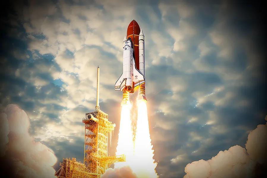 Space shuttle launching with large fire trail