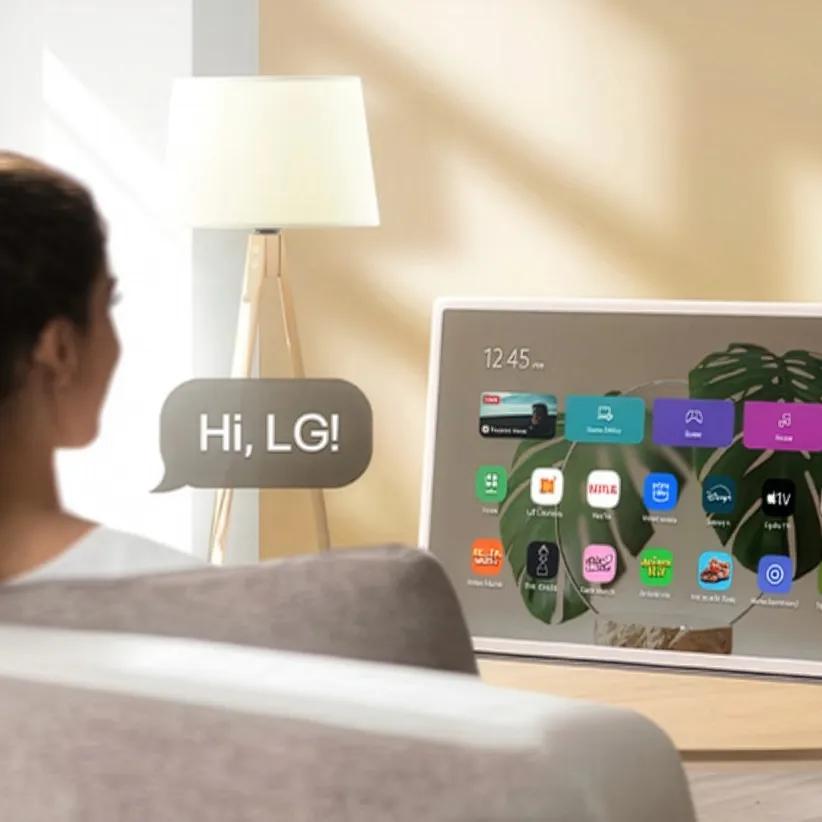 LG StanbyME 2 displaying the home screen with a voice command bubble showing 'Hi, LG!'.