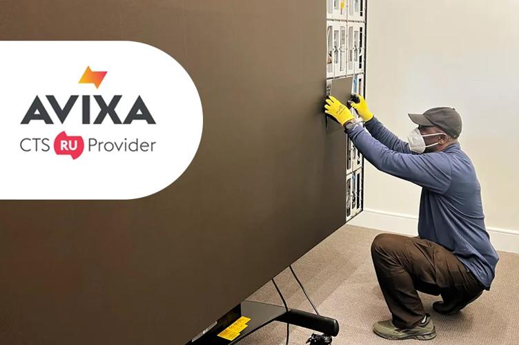 A person in protective gear works on a large panel, with the AVIXA CTS RU Provider logo on the left.
