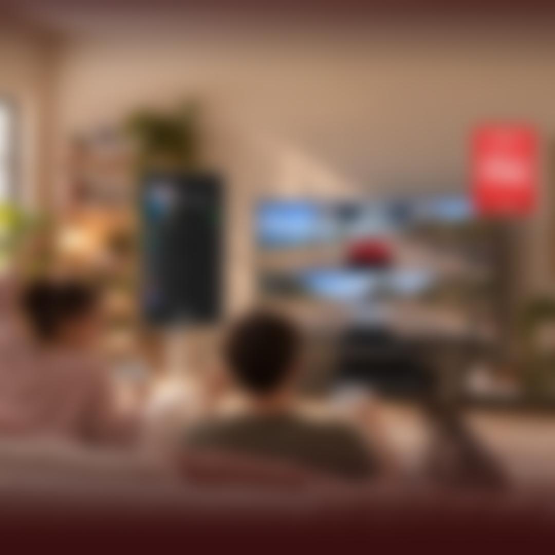 A couple plays a split-screen racing game on a large LG TV, controllers in hand, celebrating a 1st-place finish, with a French bulldog watching beside them on the couch. A portable smart display shows a "Driving Mix" playlist nearby. Cozy living room setting with plants and shelving. A "CNET People's Picks 2026 #1 TV Brand" badge appears in the upper right.