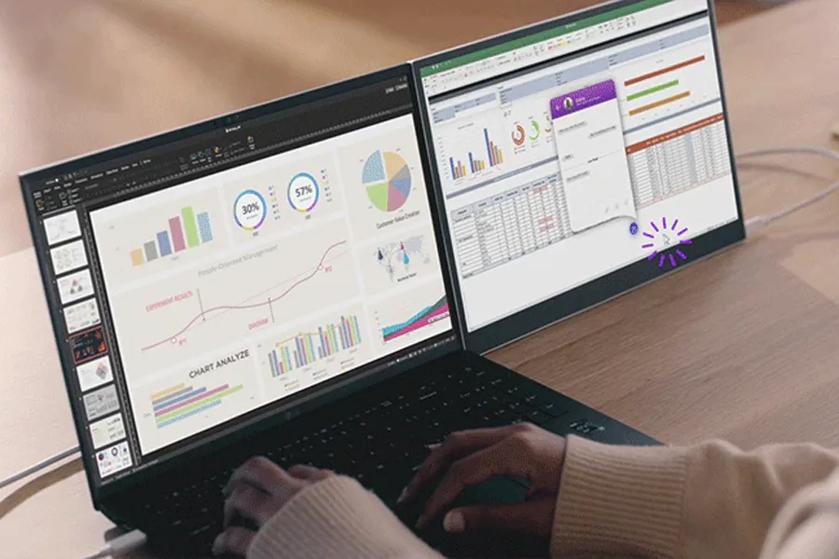 Two laptop screens display charts and spreadsheets with a person typing.