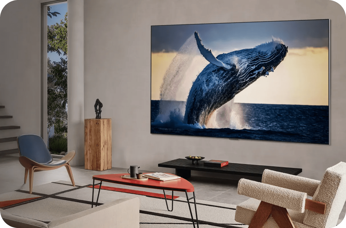 Stylish living room with a wall-mounted LG TV showing a whale leaping from the ocean in vivid detail.