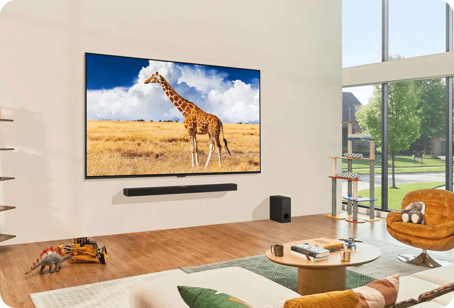 Bright modern living room with wall-mounted TV showing a giraffe, LG Soundbar below and subwoofer on the floor.