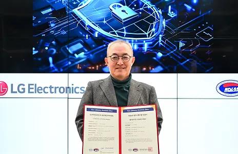 LG Electronics executive holding certificate of accreditation for cybersecurity, with digital security graphic in background.