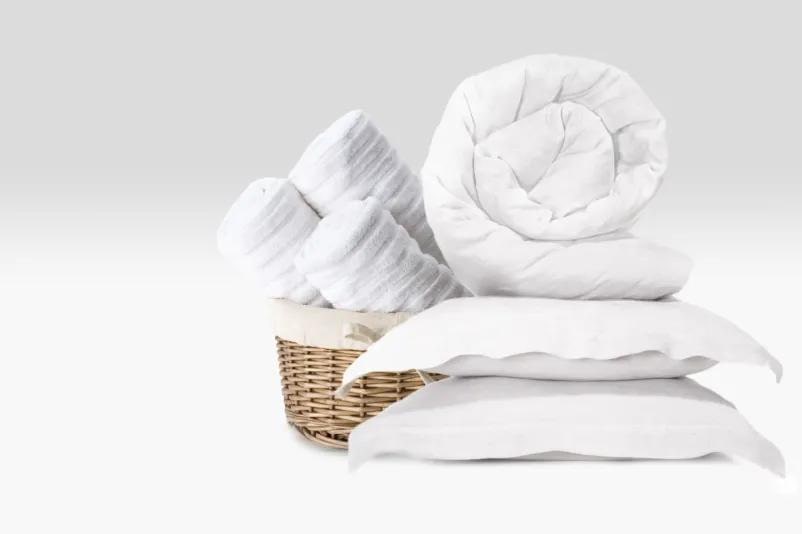 LG DLHC8402B Dryer with white bedding and towels in wicker basket showing time-saving laundry results