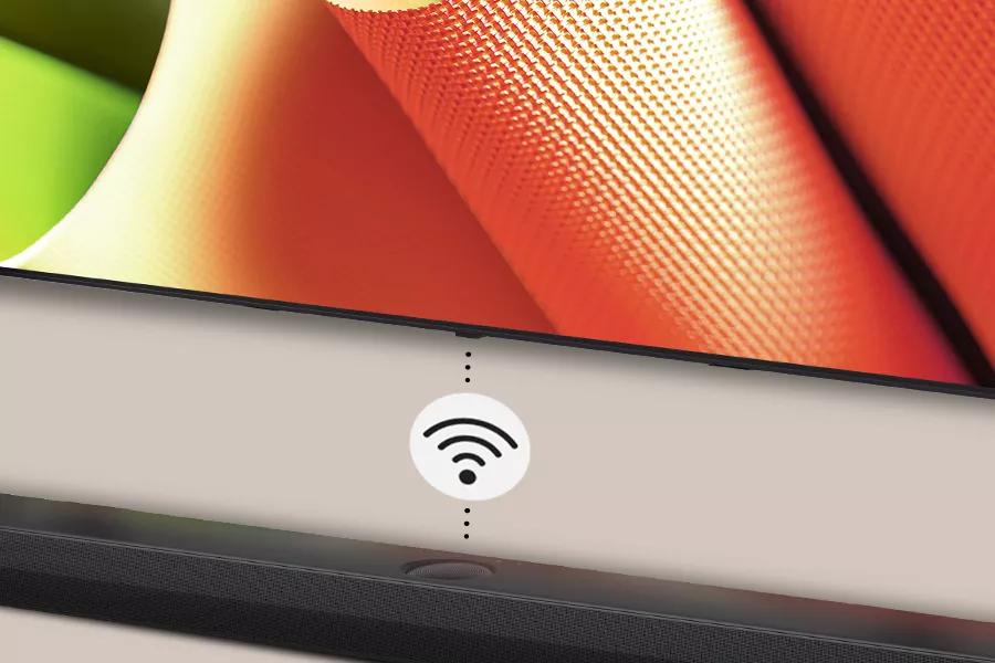 The LG OLED B4 connects wirelessly to a speaker below it.