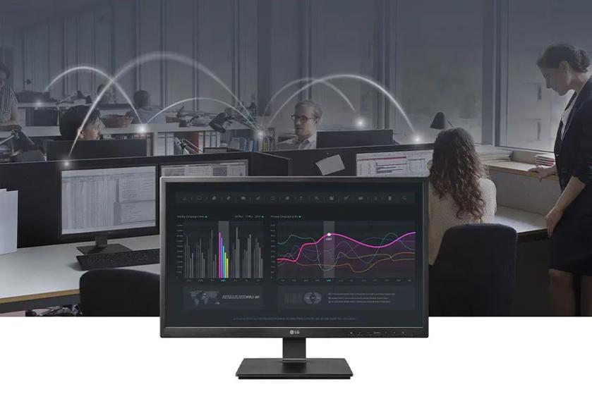 A busy office in the background, with an LG all-in-one cloud client in the foreground.