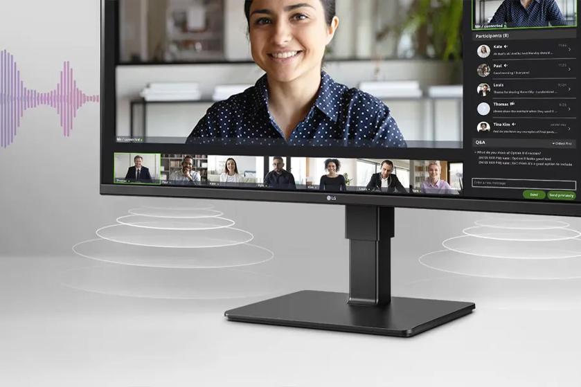 The monitor sits on a sleek black stand within a minimalistic and modern setting. Surrounding the monitor are graphical representations of sound waves indicating audio, with concentric circles emanating from the speaker area at the bottom.