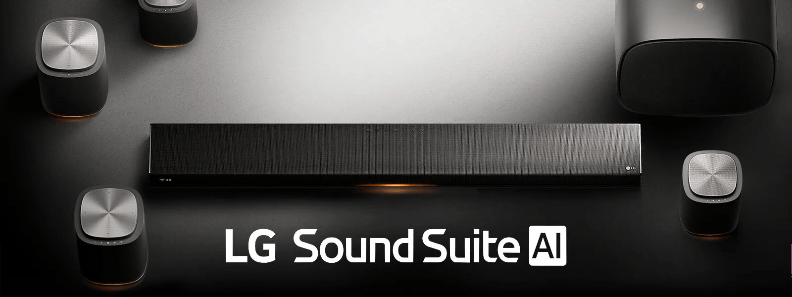 LG Sound Suite AI product display showing a soundbar with multiple sleek wireless speakers arranged around it on a neutral background with the LG Sound Suite AI logo.